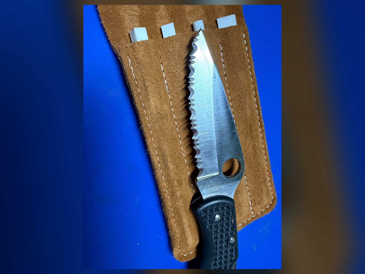 Serrated knife on leather sharpening strop